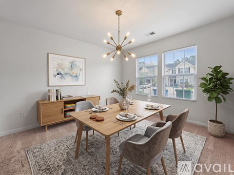 A dining room with a wooden table and chairs.