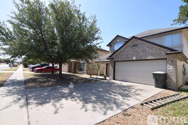 A red car is parked in front of a house.
