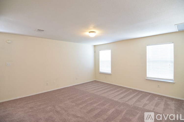 A bathroom with a toilet, sink and mirror.