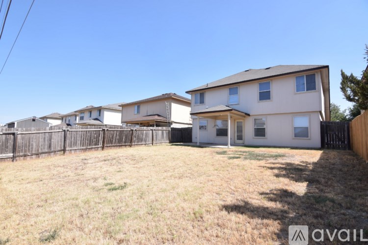 A row of houses with a fence in front of them.