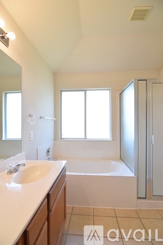 A bathroom with a sink, tub, and shower.