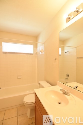 A bathroom with a toilet, sink, and bathtub.