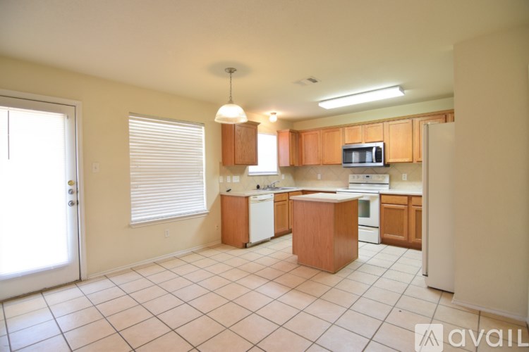A kitchen with wooden cabinets and a white refrigerator.