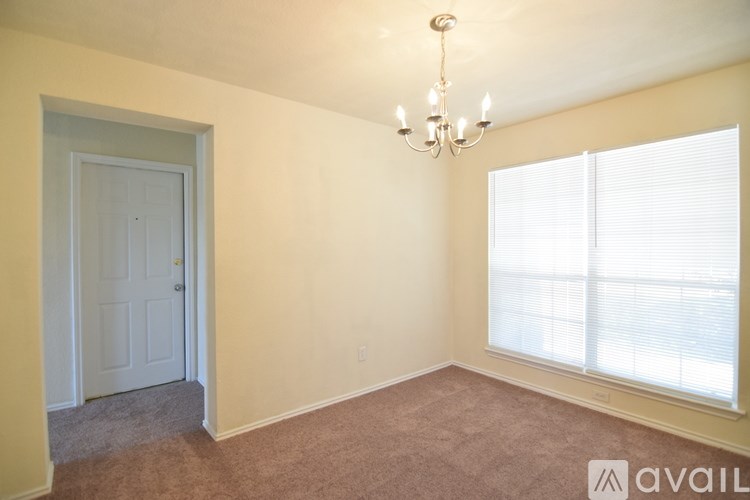 A room with a ceiling fan and a window with blinds.