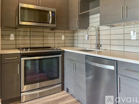 A modern kitchen with a stainless steel oven and microwave above the stove.