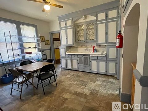 A kitchen with a table and chairs in front of a window.