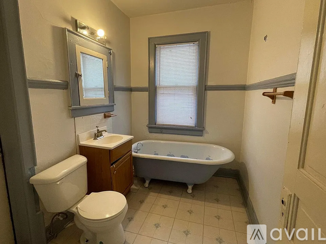 A bathroom with a toilet, sink, and bathtub.