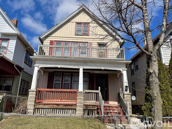 A two-story house with a red front porch.