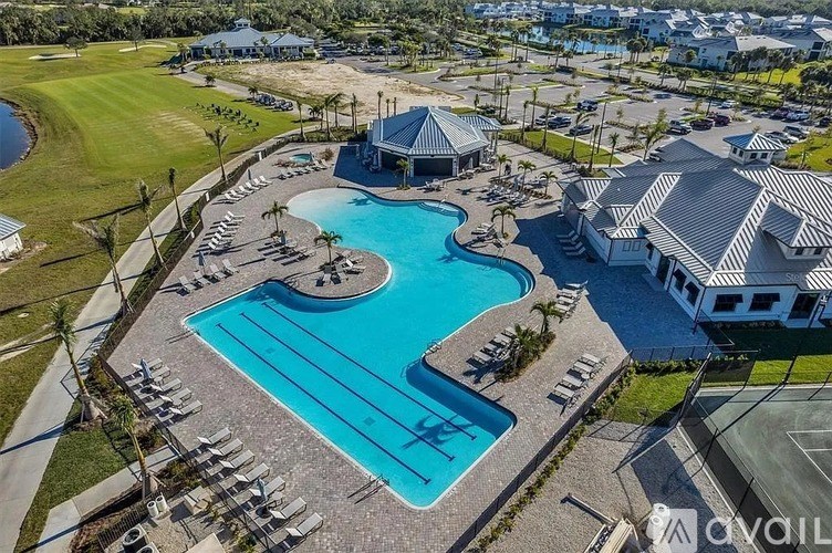 A large swimming pool with a slide and a gazebo.