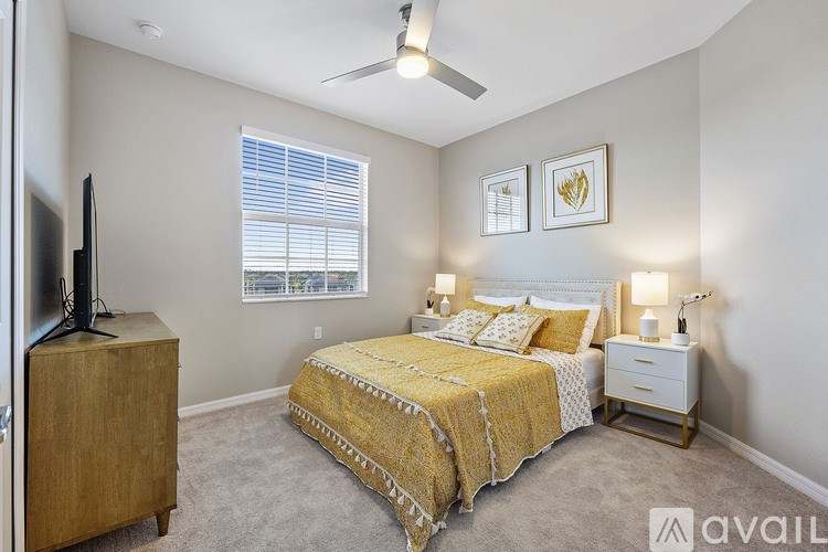A bedroom with a bed, nightstand, and television.