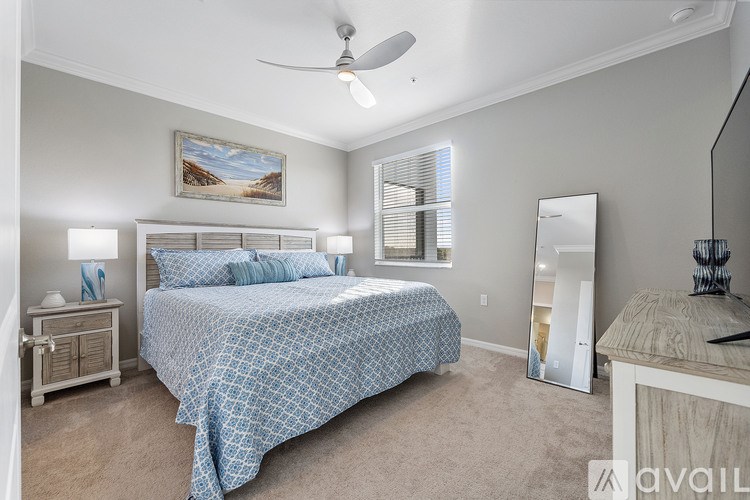 A bedroom with a bed, dresser, and mirror.
