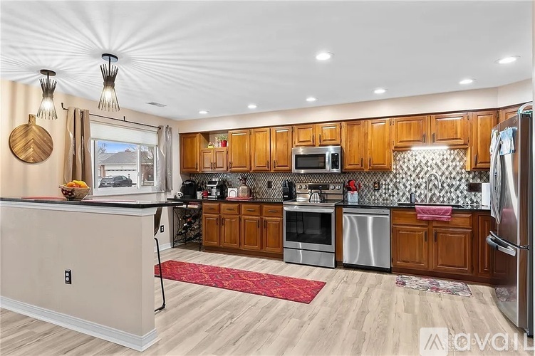 A kitchen with wooden cabinets and a white fridge.