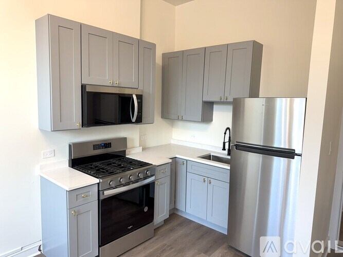A kitchen with a stove, microwave, and refrigerator.