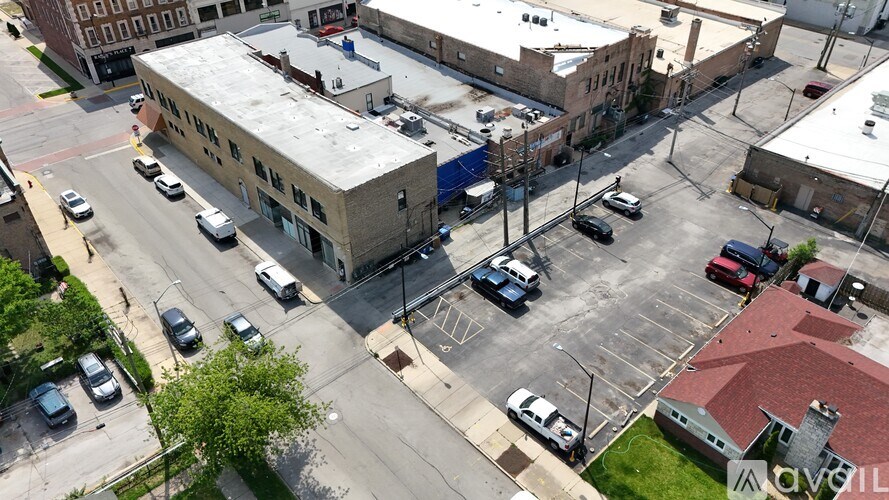 A parking lot with cars and buildings in the background.