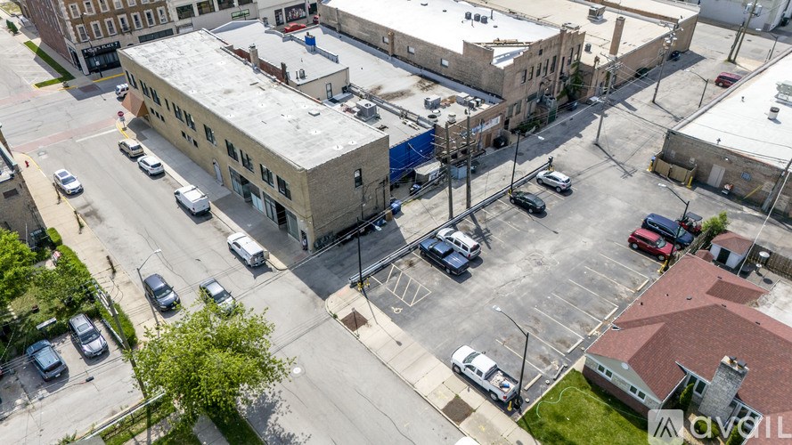 A parking lot with cars and a building in the background.