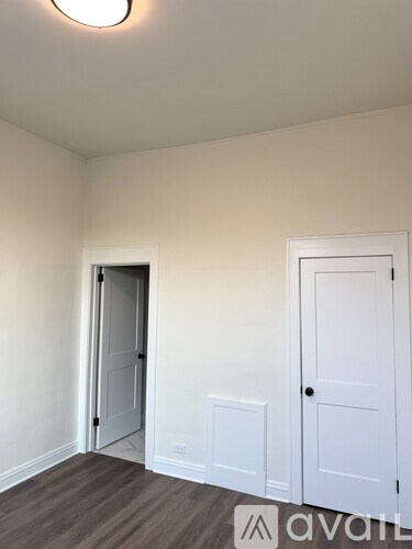 A room with a door and a wall socket.