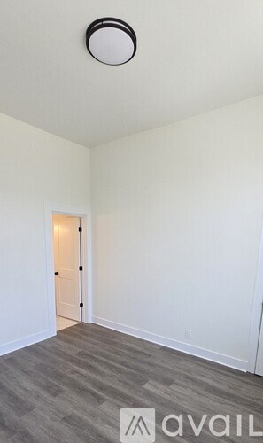 A room with a door and a light on the ceiling.