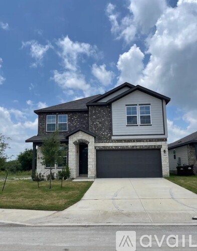 A two-story house with a garage is available for sale.