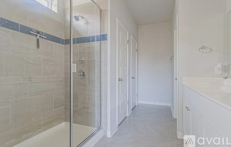 A bathroom with a walk-in shower and a sink.