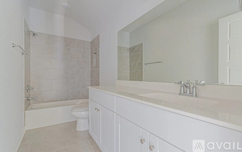 A bathroom with a white toilet, sink, and bathtub.