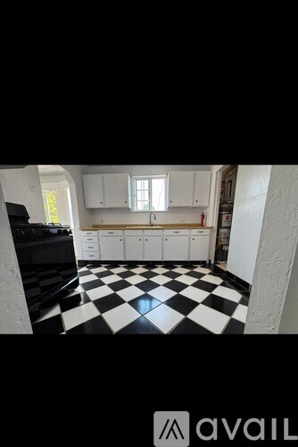 A black and white checkered floor in a kitchen.