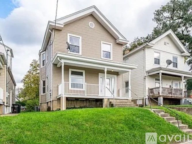 A two-story house with a front porch and a garage.