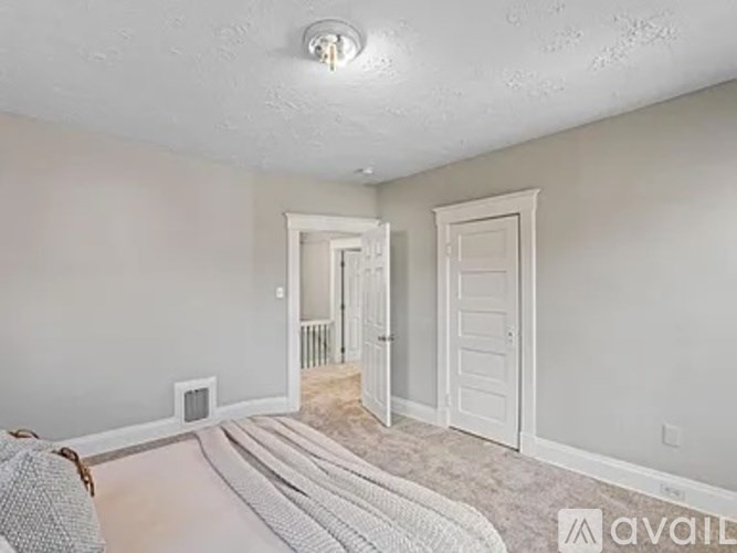 A room with a white door and a window.