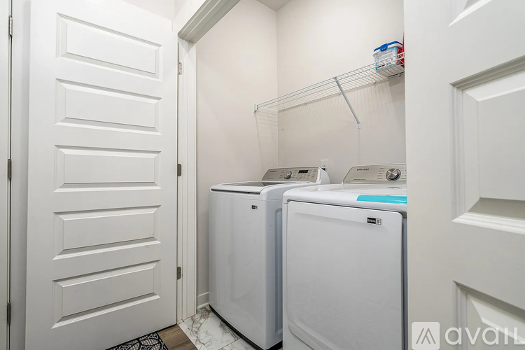 A small laundry room with a washer and dryer.