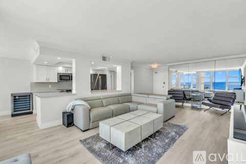 A modern living room with a large sectional sofa and a flat-screen TV.