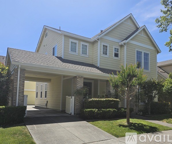 A two-story house with a garage and a driveway.