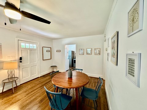 A dining room with a table and chairs.