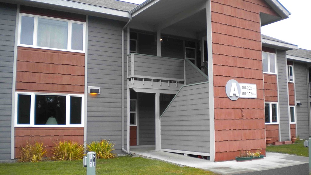 A building with a red brick facade and a grey roof.