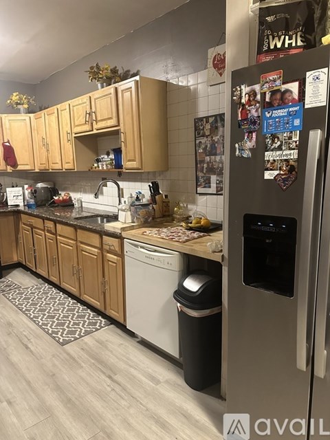 A kitchen with wooden cabinets and a fridge with magnets on it.