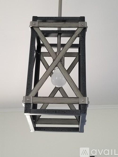 A wooden structure with a white light bulb hanging from it.