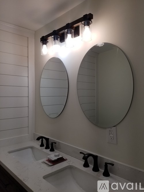 A bathroom with two sinks and a mirror.