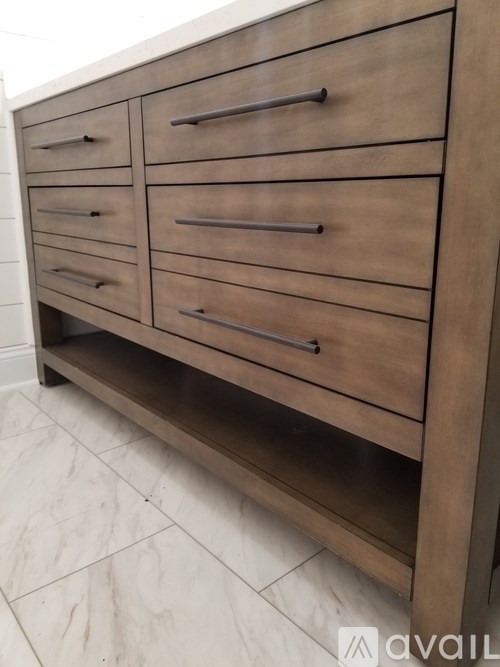 A brown wooden drawer cabinet with multiple compartments.