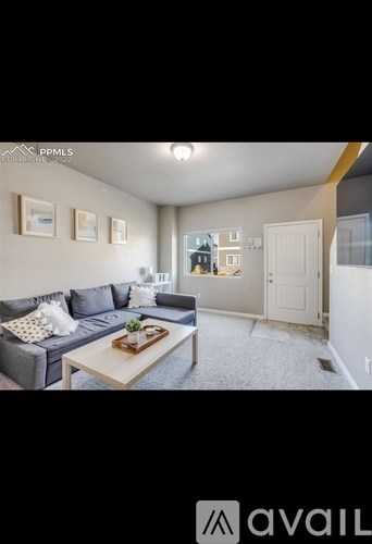 A living room with a grey couch and a coffee table.