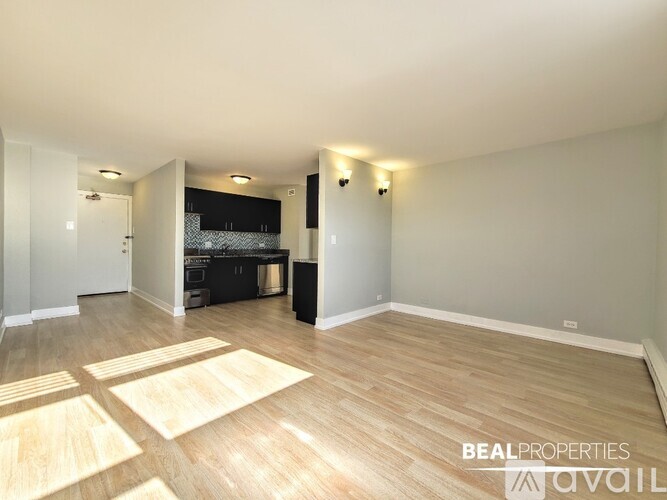 A kitchen with wooden cabinets and a black countertop.