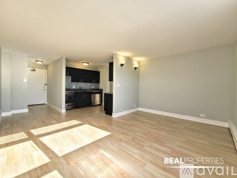 A kitchen with wooden cabinets and a black countertop.