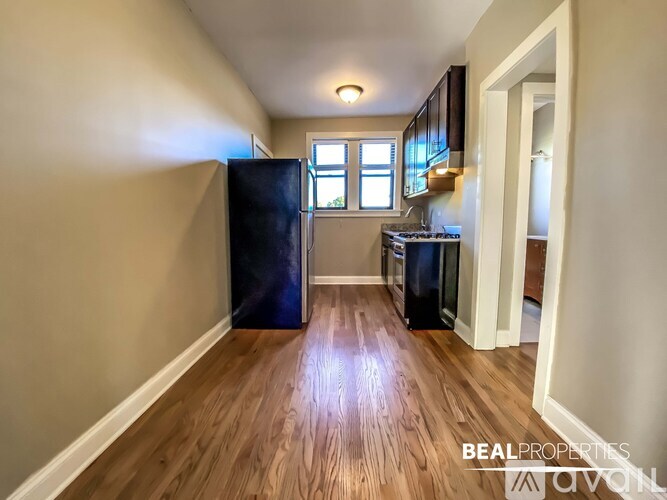 A BEALPROPERTIES sign is on a kitchen wall.