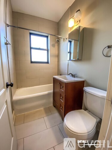 A small bathroom with a toilet, sink, and bathtub.
