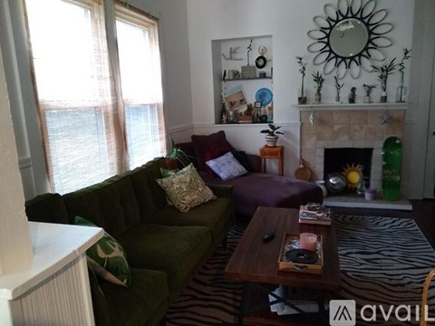 A living room with a green couch and a coffee table.