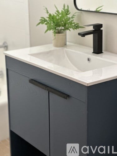A bathroom vanity with a sink and a mirror above it.