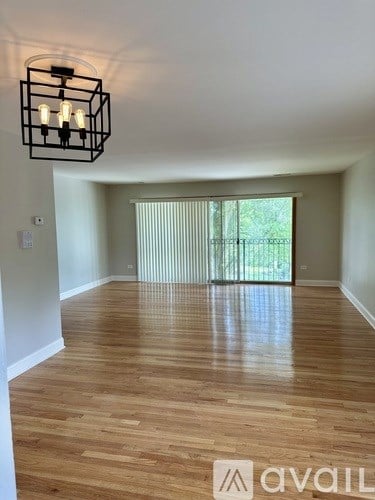 A room with wooden flooring and a light fixture.