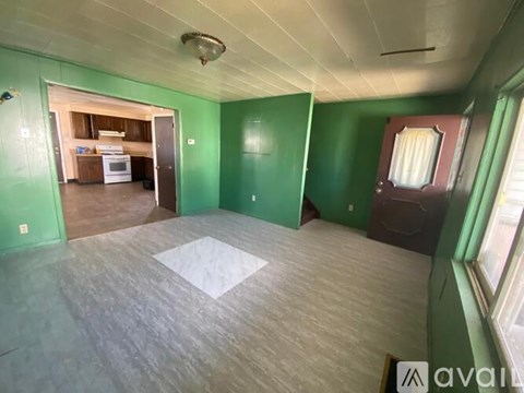 A room with green walls and a white ceiling.