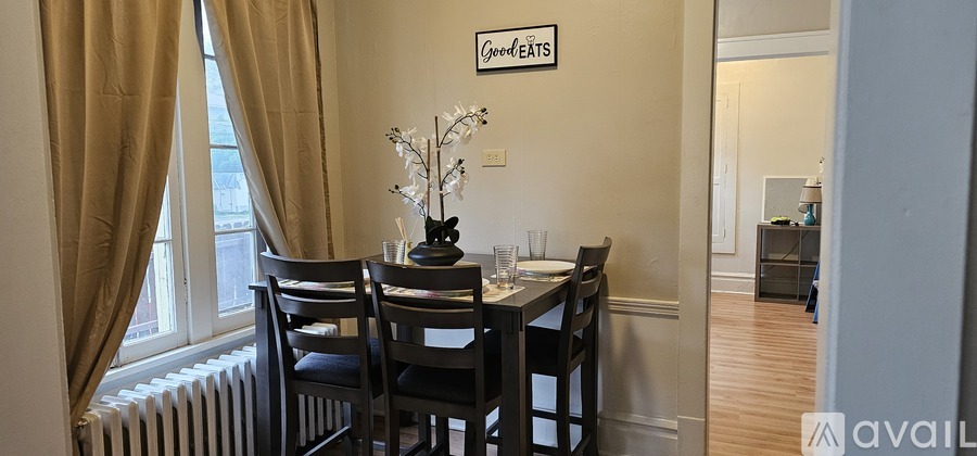 A dining room with a table set for four.