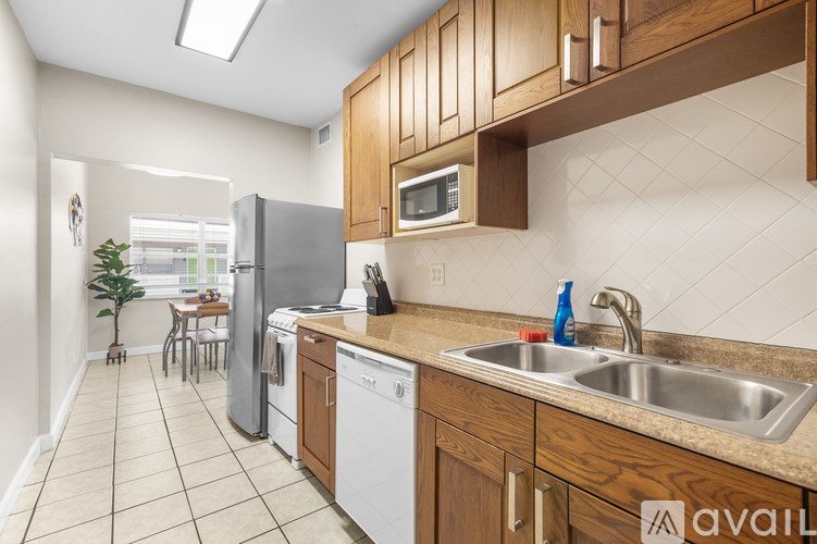A kitchen with a white dishwasher and a white refrigerator.