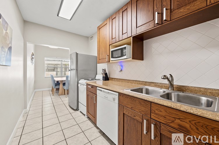 A bathroom with a blue shower curtain and a white bathtub.