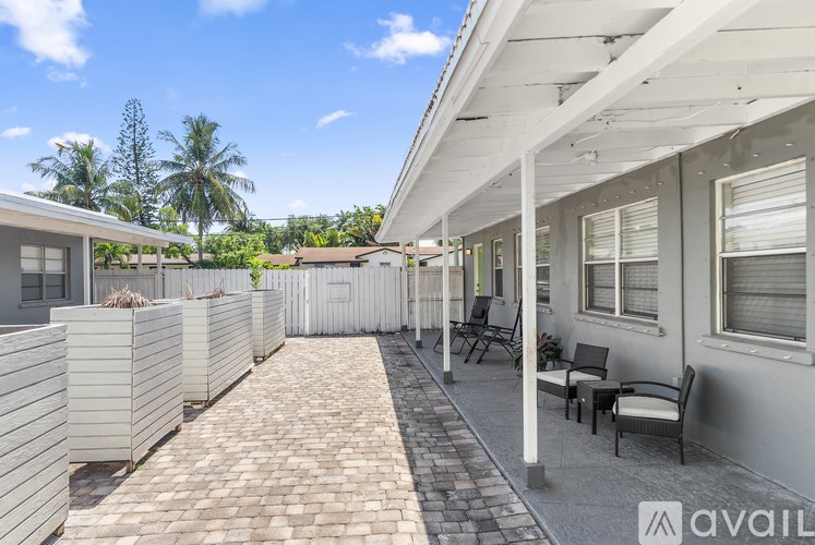 A sunny day at the beachfront with a row of houses and a clear blue sky.