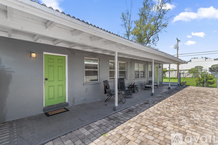 A house with a green door and a white wall.